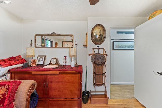 174 Cedar Ln, Gates, OR 97346 - bedroom with wood finished floors, ceiling fan, a textured ceiling, and baseboards