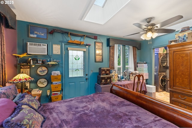 174 Cedar Ln, Gates, OR 97346 - bedroom with stacked washer / drying machine, a wall mounted air conditioner, a skylight, and a ceiling fan