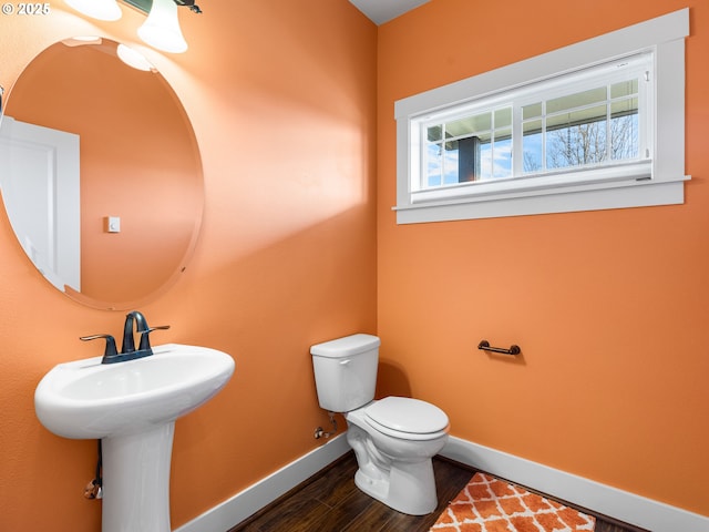 bathroom featuring hardwood / wood-style floors and toilet