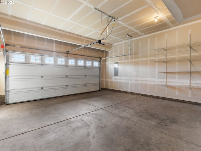 garage with a garage door opener and electric panel