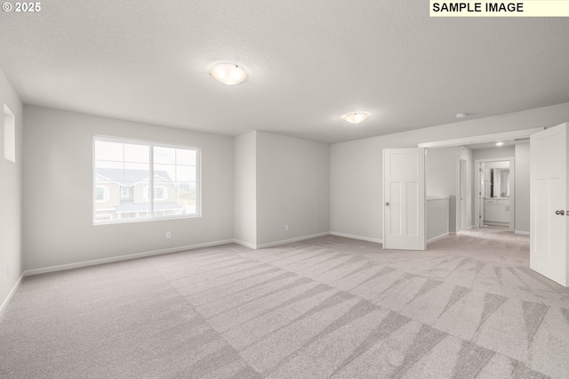 8836 SW Peia Ln, Tualatin, OR 97062 - unfurnished room with light carpet, a textured ceiling, and baseboards