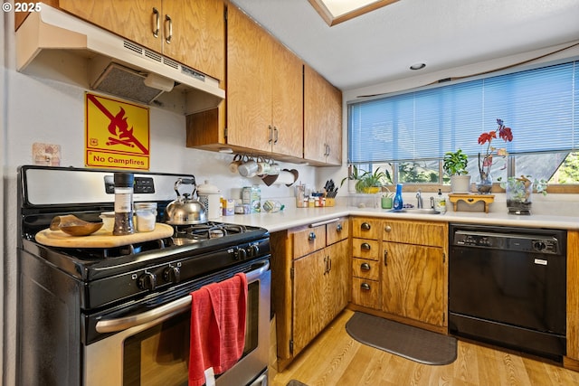 1842 NW Dogwood St, Roseburg, OR 97471 - kitchen featuring stainless steel range, dishwasher, under cabinet range hood, light wood-style floors, and light countertops