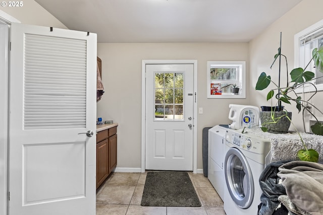 1842 NW Dogwood St, Roseburg, OR 97471 - laundry area with washer and dryer, light tile patterned floors, cabinet space, and baseboards
