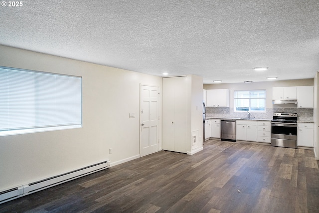 kitchen featuring dark wood-type flooring, sink, white cabinetry, stainless steel appliances, and a baseboard heating unit