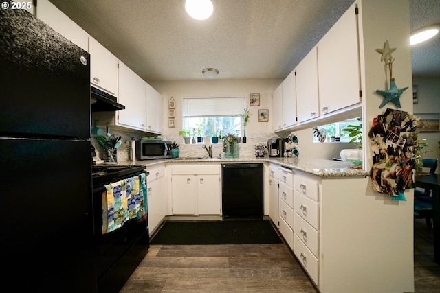 kitchen with white cabinetry, sink, a textured ceiling, and black appliances