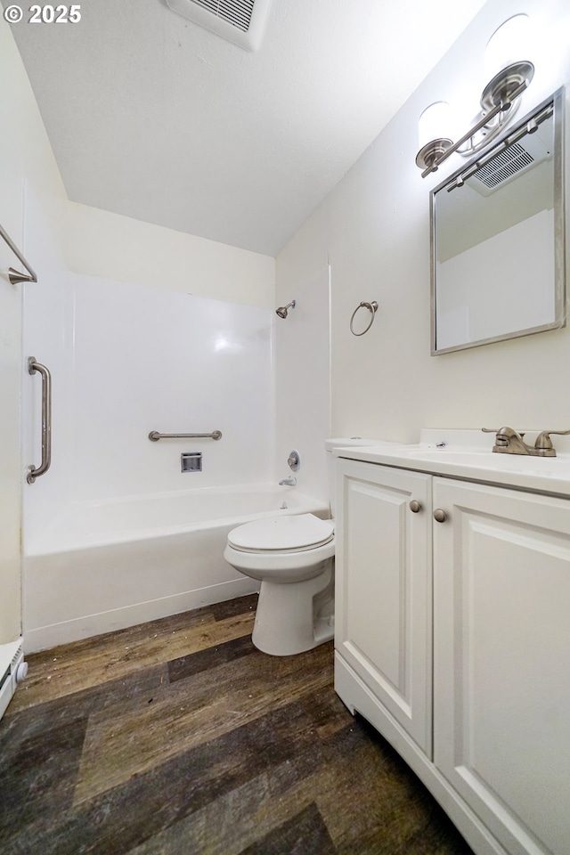 full bathroom with vanity, hardwood / wood-style flooring, toilet, and shower / bath combination