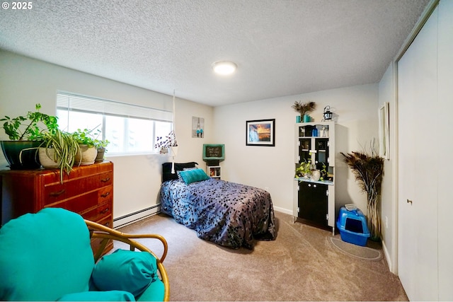 carpeted bedroom featuring baseboard heating and a textured ceiling