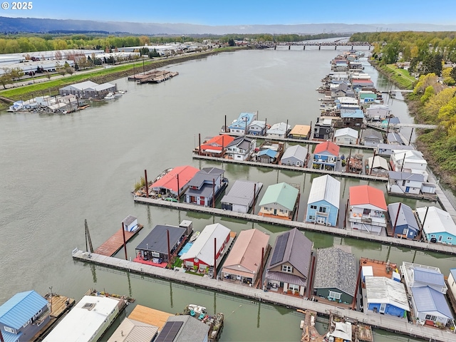 drone / aerial view featuring a water view and a residential view