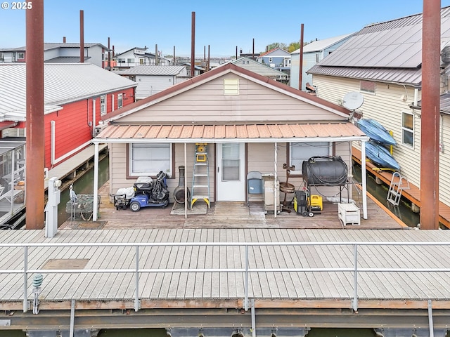 back of property with metal roof and a residential view