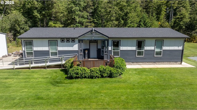 87477 Jean Dr, Bandon, OR 97411 - view of front of house featuring board and batten siding, a front lawn, and a shingled roof