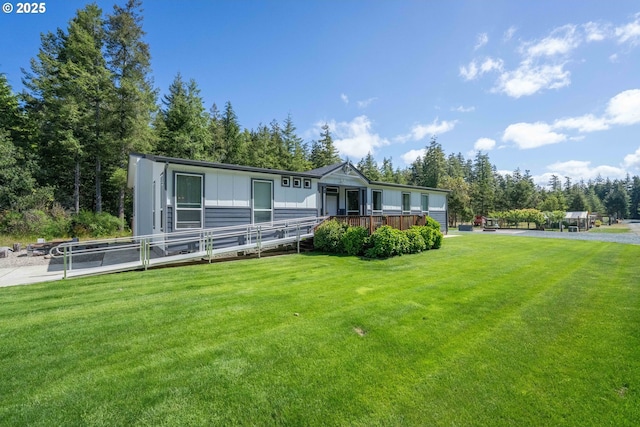 87477 Jean Dr, Bandon, OR 97411 - manufactured / mobile home featuring board and batten siding, a front lawn, and a deck