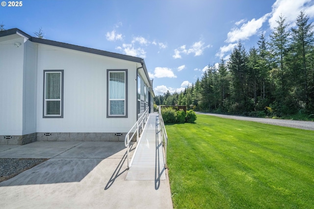 87477 Jean Dr, Bandon, OR 97411 - view of property exterior featuring crawl space, a lawn, and a patio
