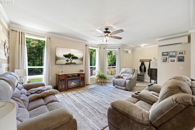 87477 Jean Dr, Bandon, OR 97411 - living area featuring a wall mounted AC, crown molding, plenty of natural light, ceiling fan, and a glass covered fireplace