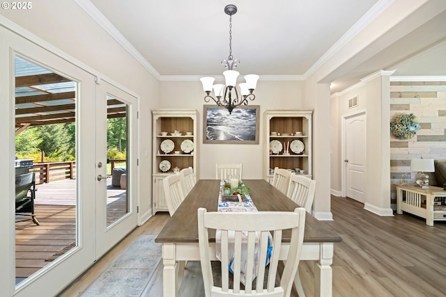 87477 Jean Dr, Bandon, OR 97411 - dining space featuring light wood-style floors, a chandelier, ornamental molding, and baseboards