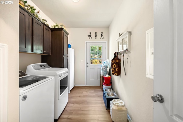 87477 Jean Dr, Bandon, OR 97411 - laundry area featuring washer and dryer, cabinet space, light wood finished floors, baseboards, and water heater