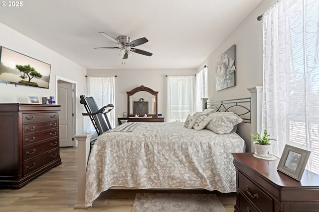87477 Jean Dr, Bandon, OR 97411 - bedroom featuring light wood finished floors and ceiling fan