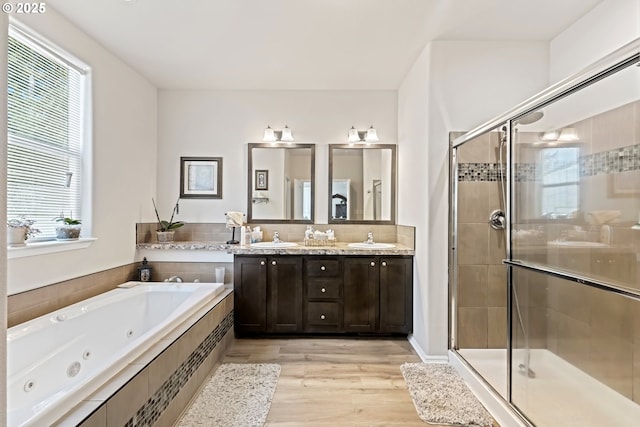 87477 Jean Dr, Bandon, OR 97411 - full bathroom featuring a shower stall, a jetted tub, double vanity, and wood finished floors