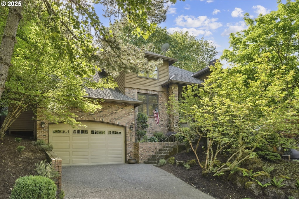 view of front of house with brick siding, asphalt driveway, a shingled roof, and a garage