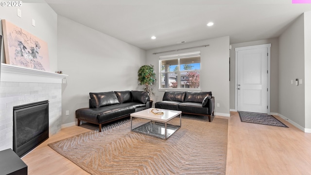 11649 SE Pleasant Valley Pkwy, Happy Valley, OR 97086 - living room featuring light wood-style flooring, a brick fireplace, and recessed lighting