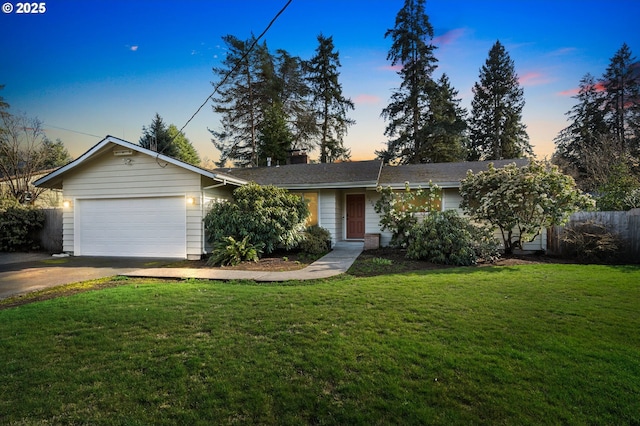 single story home featuring driveway, an attached garage, fence, and a yard