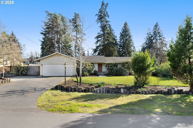 single story home featuring a front yard, driveway, an attached garage, and fence