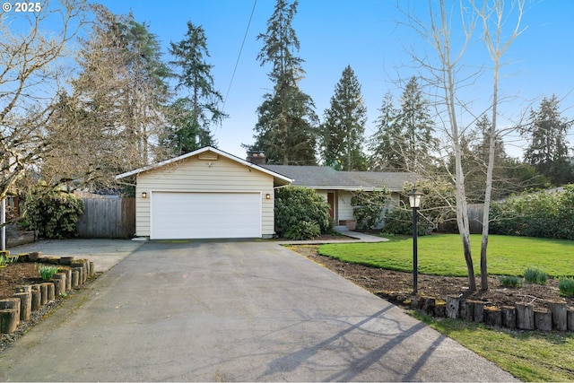 ranch-style house with driveway, a garage, a chimney, fence, and a front lawn