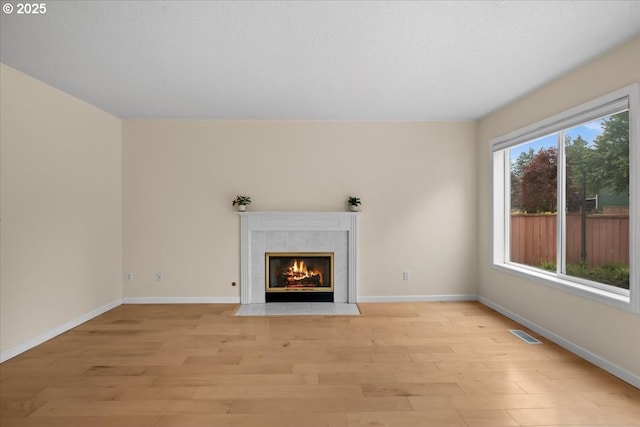 2290 N Irvine St, Cornelius, OR 97113 - unfurnished living room with light wood finished floors and a tiled fireplace