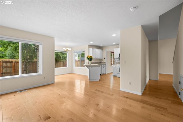 2290 N Irvine St, Cornelius, OR 97113 - unfurnished living room with a chandelier, light wood-type flooring, and recessed lighting