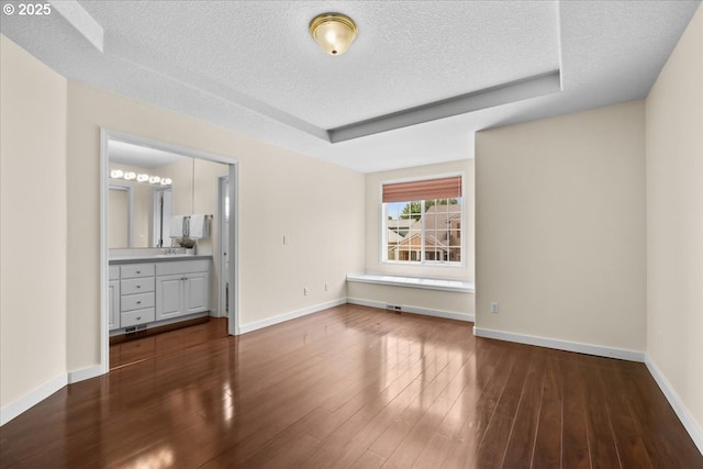 2290 N Irvine St, Cornelius, OR 97113 - empty room featuring a textured ceiling, dark wood-style flooring, and a raised ceiling