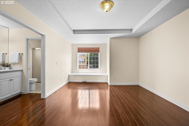 2290 N Irvine St, Cornelius, OR 97113 - unfurnished living room featuring a raised ceiling, a textured ceiling, and dark wood finished floors