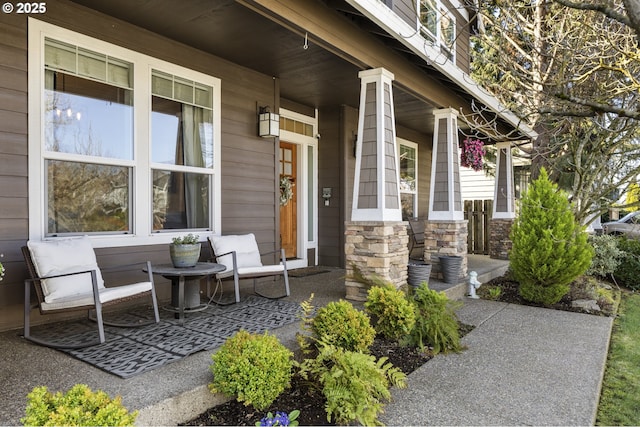 entrance to property featuring stone siding and covered porch