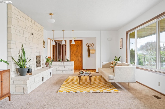 carpeted living area with visible vents and baseboards