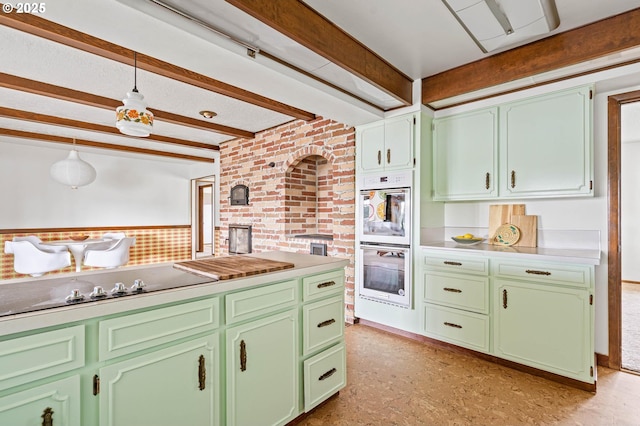 kitchen with light countertops, double wall oven, beamed ceiling, and green cabinetry