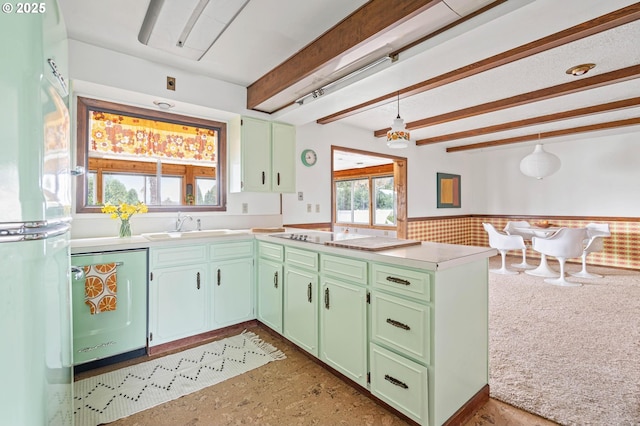 kitchen with a wainscoted wall, a sink, freestanding refrigerator, green cabinetry, and dishwasher