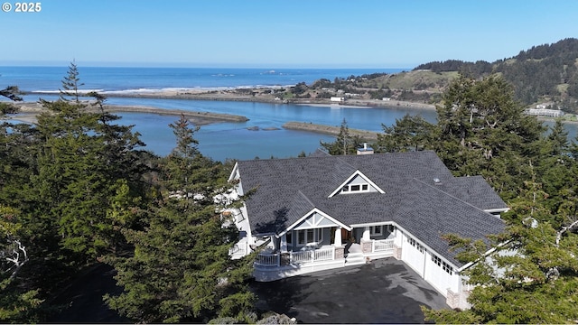 birds eye view of property with a water view