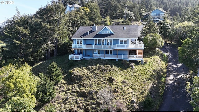 drone / aerial view featuring a forest view