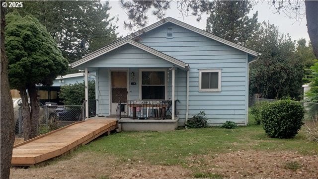 view of front of property with a front yard and covered porch