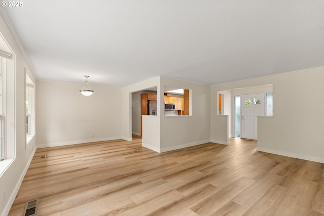 420 Mar Loop, Eugene, OR 97401 - unfurnished living room with light wood-style flooring, baseboards, and crown molding