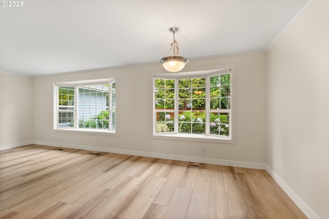 420 Mar Loop, Eugene, OR 97401 - unfurnished dining area with ornamental molding, light wood finished floors, and baseboards