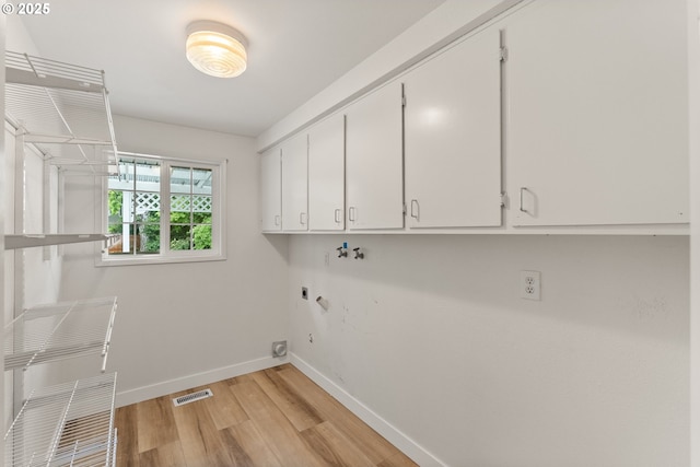 420 Mar Loop, Eugene, OR 97401 - washroom with cabinet space, light wood-style floors, baseboards, electric dryer hookup, and washer hookup
