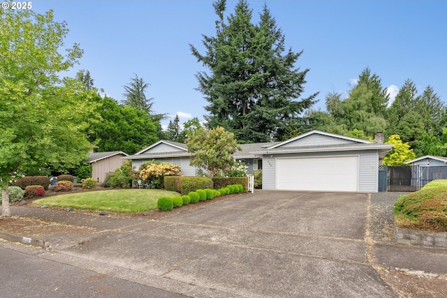 420 Mar Loop, Eugene, OR 97401 - single story home with a garage, concrete driveway, a chimney, and a gate