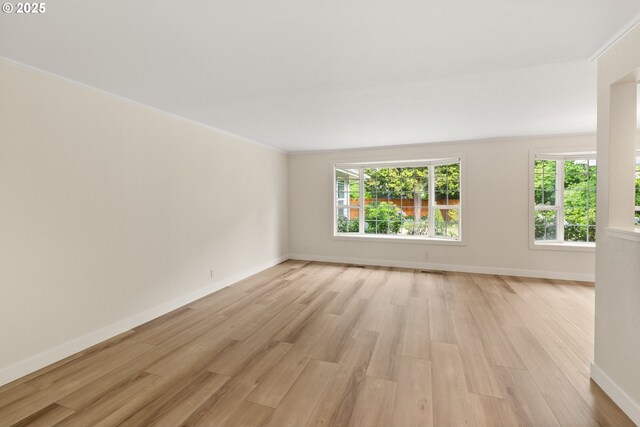 420 Mar Loop, Eugene, OR 97401 - empty room with plenty of natural light, light wood-style floors, baseboards, and ornamental molding