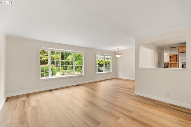 420 Mar Loop, Eugene, OR 97401 - unfurnished living room featuring baseboards, light wood-style floors, and crown molding