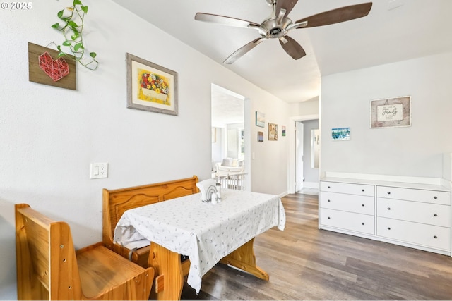 dining area featuring baseboards, ceiling fan, and wood finished floors