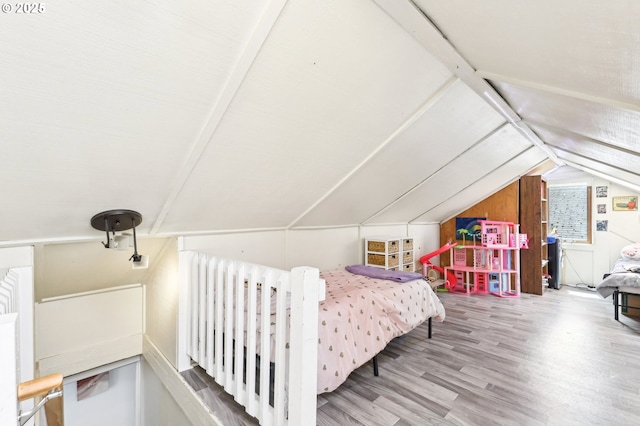 bedroom featuring vaulted ceiling and wood finished floors