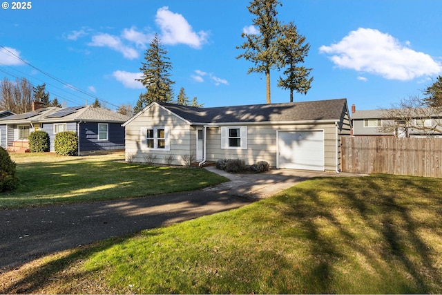 single story home featuring a garage and a front lawn