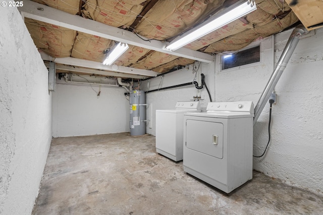 washroom with water heater and independent washer and dryer