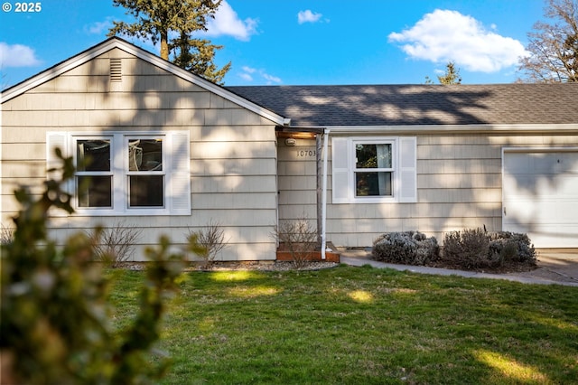 single story home featuring a garage and a front yard