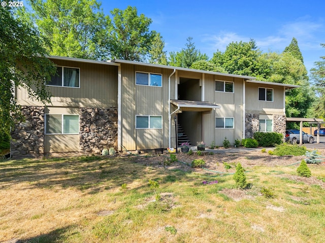 6801 SW Terri Ct Unit 60, Portland, OR 97225 - rear view of property with stone siding, stairs, and a lawn