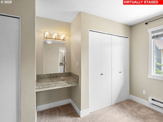 6801 SW Terri Ct Unit 60, Portland, OR 97225 - unfurnished bedroom featuring a baseboard heating unit, carpet flooring, a closet, and built in study area